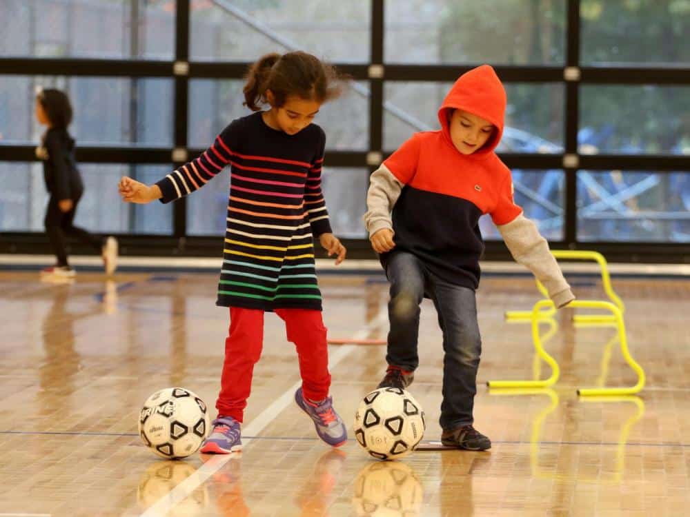 Two kindergarteners in PE class