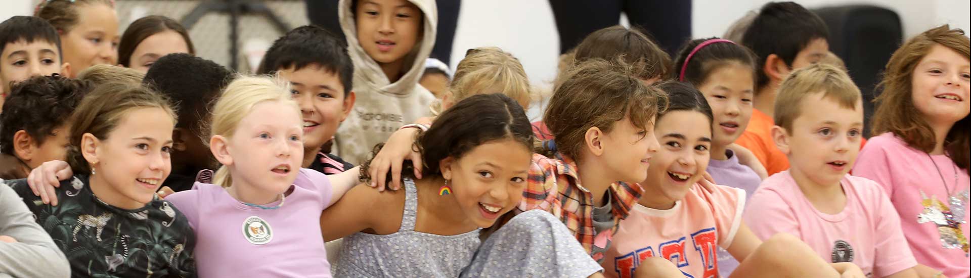Smiling students seated together arm in arm